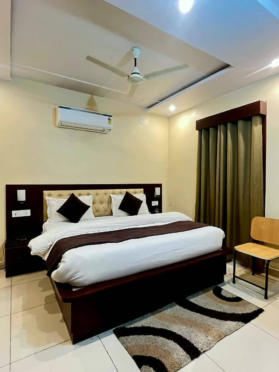 A guest room with a chair and a side table by the window.