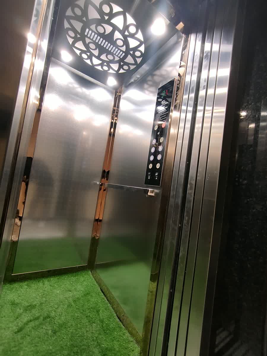 Inside the lift, its steel doors closing.