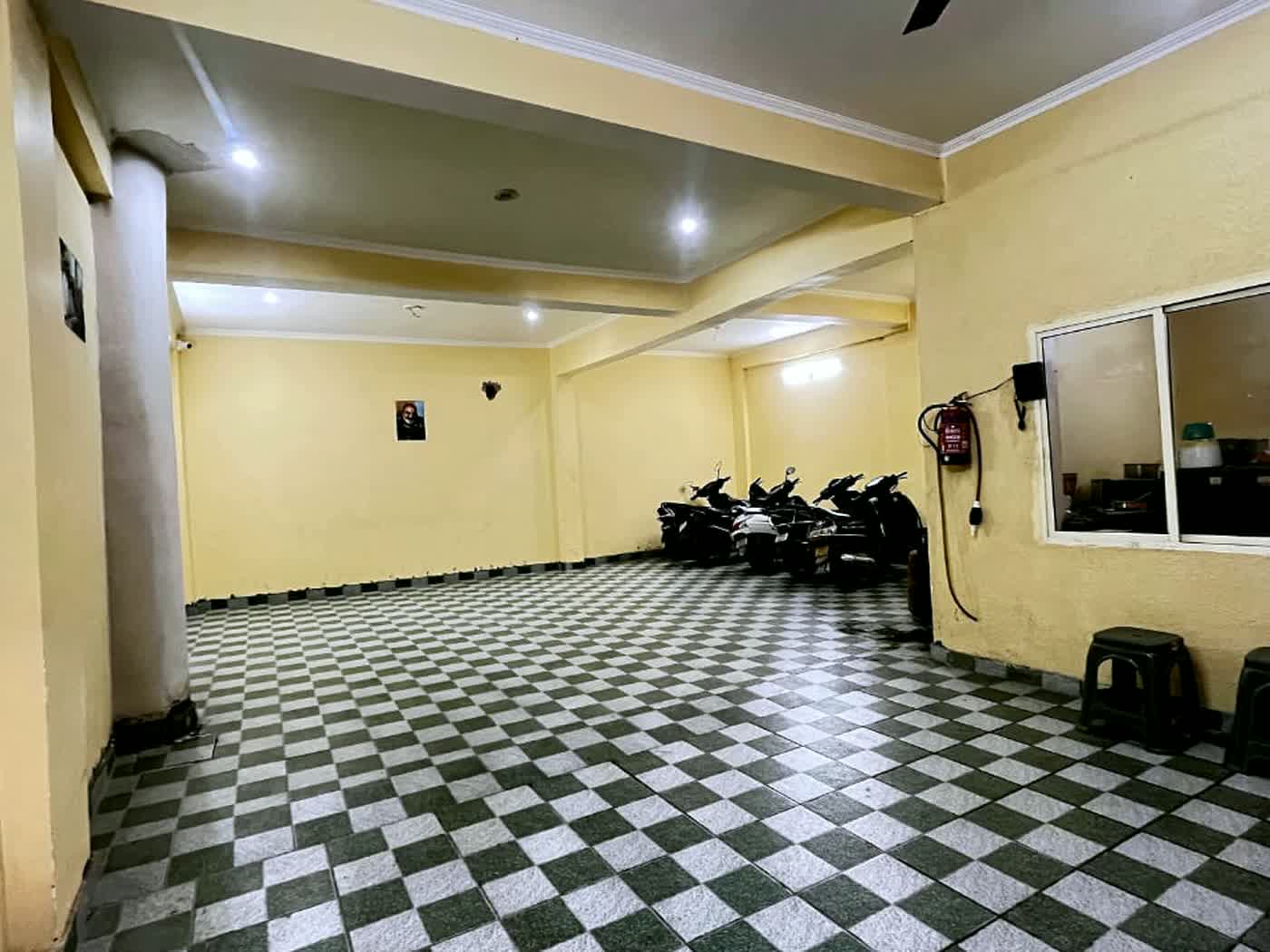 The covered parking floor, with a chequerboard tile floor.